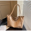 Detailed macro view of beige tote bag showing textured leather finish and practical front pocket - Khaki