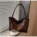 Detail view of retro coffee PU leather tote bag with fine texture and large front pocket - Coffee