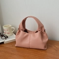 Close-up of pink cloud bag with lychee grain texture and gold metal hardware - Pink