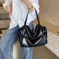 Borsa tote in vernice nera lucida con spalline lunghe da donna in un ambiente di vita reale - Nero