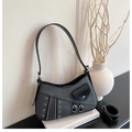 Detail view of grey and black saddle bag featuring punk metal eyelets and belt strap buckle - Black