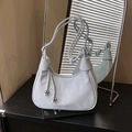 Minimalist light blue hobo bag with knotted strap and silver bead details in a studio setting - Blue