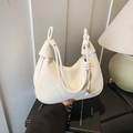 Chic cream white hobo shoulder bag featuring stylish knot detail and silver ball charm - Off White