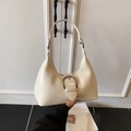 Minimalist cream-colored dumpling underarm bag with a large silver ring buckle detail - Off White
