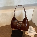 Deep brown glossy patent leather hobo bag with a silver horseshoe buckle and crescent shape - Brown