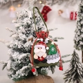 Detail of Christmas Santa burlap gift bag with drawstring on a festive tree - Santa Claus Gift Tote Bag