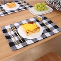 Classic black and white checkered fabric placemats in a modern Nordic home dining setting - Black and White Plaid / Placemat