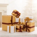 Champagne gold and white Christmas gift boxes with satin ribbons on white plush rug - Gold White Style