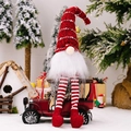 Christmas gnome doll with long red striped knit hat and dangling legs on vintage car - Red