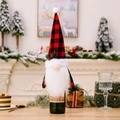 Festive Christmas gnome wine bottle cover with red buffalo plaid hat and white beard decoration - Plaid Gnome Bottle Cover