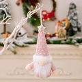 Pink knitted Christmas gnome ornament with white patterns and a sparkling gold star - Pink