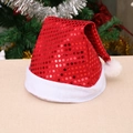 Classic red sequin Christmas hat with white plush trim against a festive tree background - Red