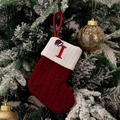 Macro detail of red knitted Christmas stocking with embroidered letter I and a mini Santa hat - Style I (Red Knit Embroidered I)