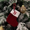 Detail view of red knitted Christmas stocking with white cuff and embroidered letter N - Style N (Red Knit Embroidered N)
