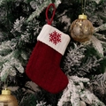 Detail of red cable-knit Christmas stocking with white snowflake embroidery on tree - Snowflake (Red Knit Embroidered Snowflake)