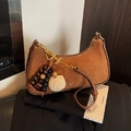 Brown suede crescent bag with gold-tone H-charm and beaded accessory details - Suede Brown With Pendant