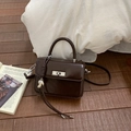 Elegant dark brown leather handbag with silver twist lock and chic heart pendant - With Pendant / Coffee