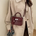 Elegant wine red patent leather small square bag with silver turn-lock and shoulder strap - With Pendant / Red