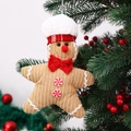 Nahaufnahme eines Lebkuchenmann-Anhängers aus Cord am Weihnachtsbaum mit roten Beeren - Stern Stil Weiblich