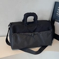 Black travel duffel bag with grey checkered drawstring pocket and adjustable strap - Black