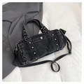 Detail shot of vintage washed black denim bowling bag with silver metallic studs and strap - Black