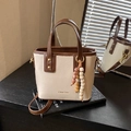 Retro cream bucket bag with brown trim, wooden bead charm and long shoulder strap - Off White