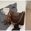 Detail of dark brown lychee textured shoulder bag with gold chain and teddy bear charm - With Charm / Coffee