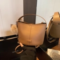 Chic beige lychee leather bucket bag with plush charm and stylish leopard detail - With Pendant / Brown