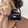 Classic black leather square bag with silver twist lock and top handle in minimalist style - Black