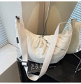 Detail of white moon bag with braided zipper pull and black brand tag on side - Off White