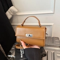 Vintage brown leather crossbody bag with silver twist lock and round handle handle - Brown