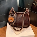 Dark brown oil wax leather bucket bag with beige contrast trim and orange plush charm - Coffee with Pendant