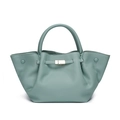 Close-up of pebble leather texture and gold metal buckle on a green fashion handbag - Light Green