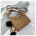 Close-up of brown PU leather bucket bag with metal lock detail and plush ball charm - Khaki with Pendant