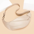Detail view of beige crescent bag featuring unique side knot and adjustable shoulder strap - Khaki