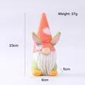 Easter gnome plush toy with orange polka dot hat and bunny ears on white background - Pink