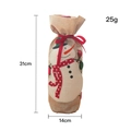 Christmas burlap wine bottle cover featuring an embroidered snowman with red ribbon bow - Snowman