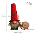 Christmas gnome doll in red hat and green suit holding a burlap gift bag - Red Top Hat Faceless Doll