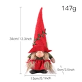 Gnome de Noël avec grand chapeau rouge à spirales et tresses brunes en position assise - Nain Chapeau Pointu Rouge