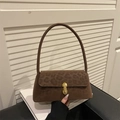Retro leopard print shoulder bag with golden buckle on a white book minimalist background - Brown