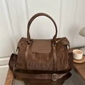 Brown large travel bag with pleated texture, carrying handles and wide shoulder strap - Brown