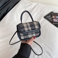 Detail view of mini plaid crossbody bag in black and white tweed with leather handle and strap - Black