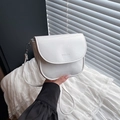 White leather saddle crossbody bag with metal hardware and minimalist flap design - White
