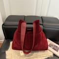 Minimalist burgundy suede tote bag with leather handles on sofa for fall commute - Red