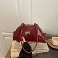 Chic burgundy patent leather bowling bag with glossy finish and silver metal logo plaque - Red