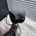 Glossy black patent leather saddle bag with flap closure and adjustable shoulder strap - Black