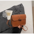 Dettaglio di borsa a tracolla vintage caramello con fibbia in corno e cuciture - Marrone