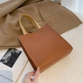 Chic brown leather tote bag with white stitching and beige handles for office use - Brown