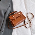 Retro brown glossy faux leather handbag for women with dual gold buckle flap and crossbody strap - With Pendant / Brown