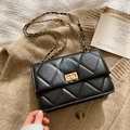 Elegant black quilted crossbody bag with gold rotating clasp and chain strap detail - Black
